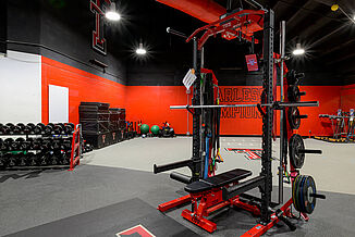 Texas Tech Volleyball's weight training room in United Supermarkets Arena features team branded equipment.