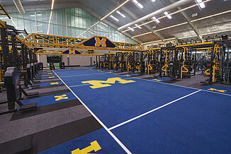 University of Michigan's football performance center with custom colors and logos University of Michigan's football performance center with custom colors and logos