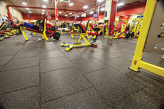 Custom colored REGUPOL aktivpro tiles seamlessly coordinate with the theme of Retro Fitness Stroudsburg.