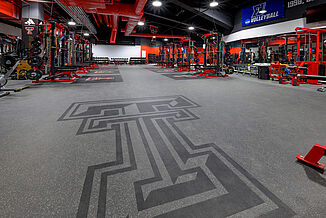 Full view of the inlaid Texas Tech logo in the entrance of the volleyball weight room in United Supermarkets Arena.