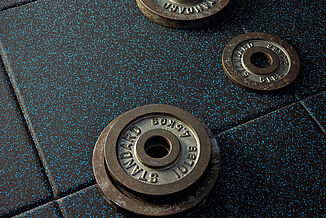 Temple University Fitness - Weights and REGUPOL aktivpro A set of weights rests directly on a REGUPOL aktivpro flooring at Temple University fitness center.