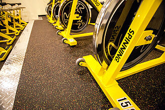 Upclose view of the REGUPOL aktiv flooring in Retro Fitness Stroudsburg in the spin bike room.