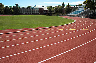 Curve in Franklin and Marshall REGUPOL champion AG track leading to the stadium seating offered for fans.