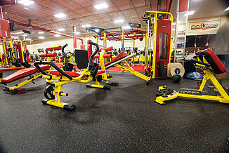 Retro Fitness Stroudsburg with vibrant yellow and red equipment for fitness members, featuring REGUPOL rubber floors.